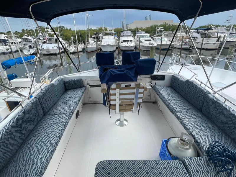 Slide: The Image of 1986 Kha Shing Spindrift yacht interior with wooden helm, seating, and nautical decor. - 6