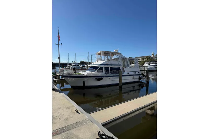 Slide: The Image of 1986 Kha Shing Spindrift yacht docked at marina under clear blue sky. - 60