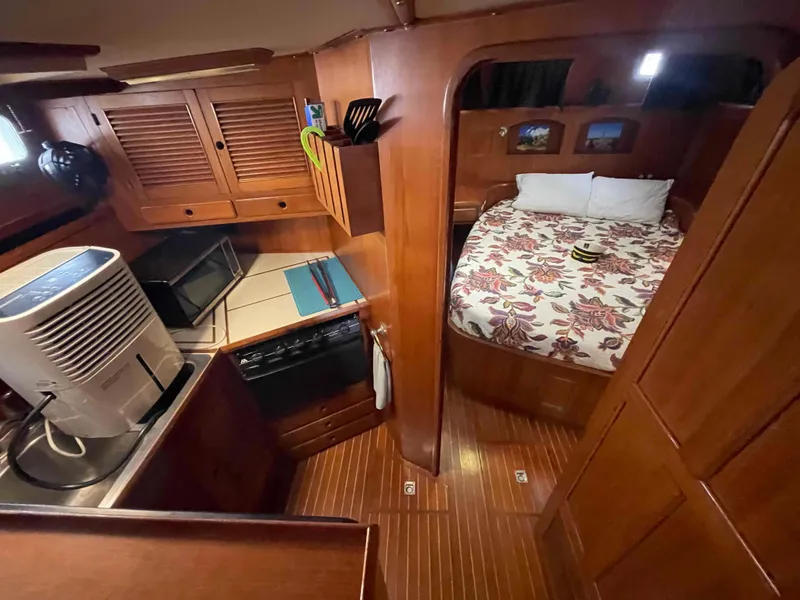 Slide: The Image of Bunk beds in 1986 Kha Shing Spindrift yacht cabin with wooden interior. - 9