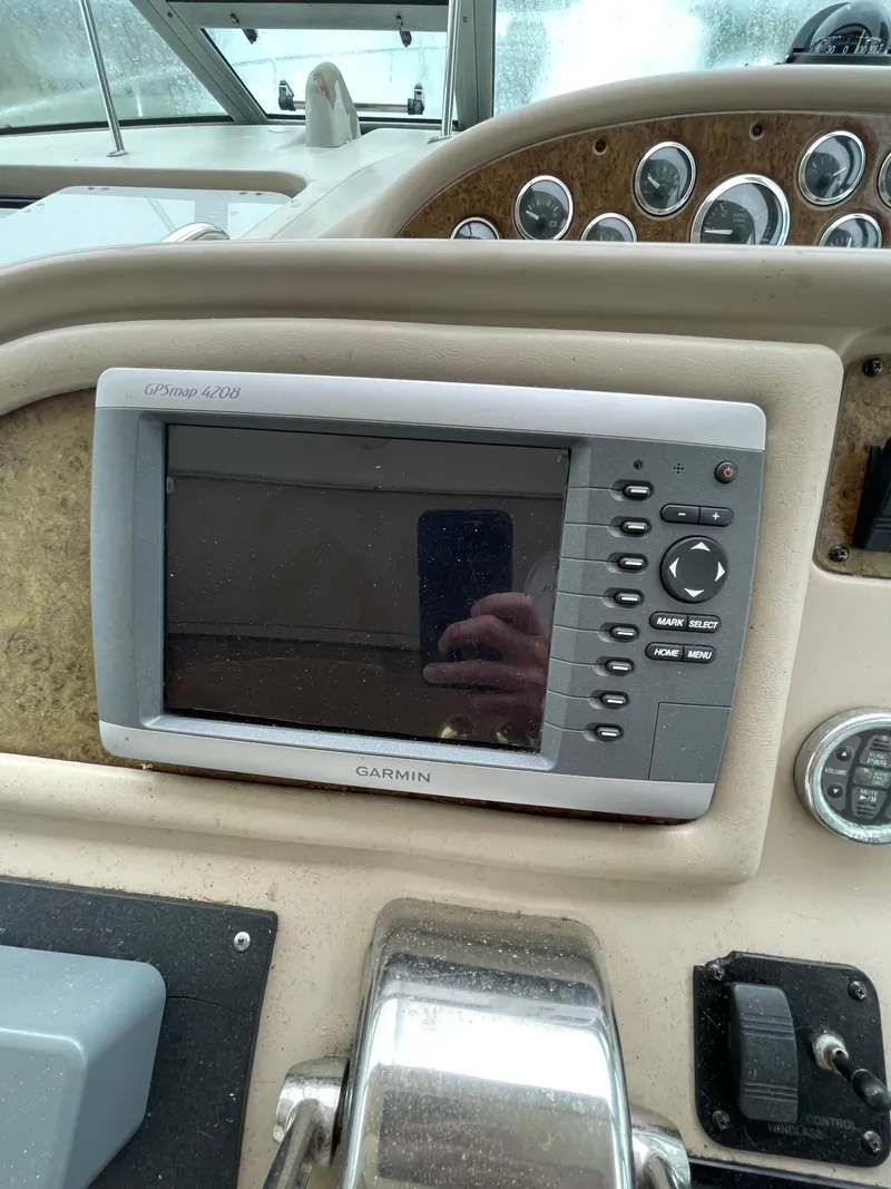 Slide: The Image of Garmin GPS on 2001 Sea Ray 310 Sundancer dashboard with control panel. - 13