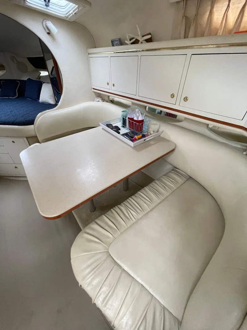 Slide: The Image of 2001 Sea Ray 310 Sundancer interior with dining area and white seating. - 16