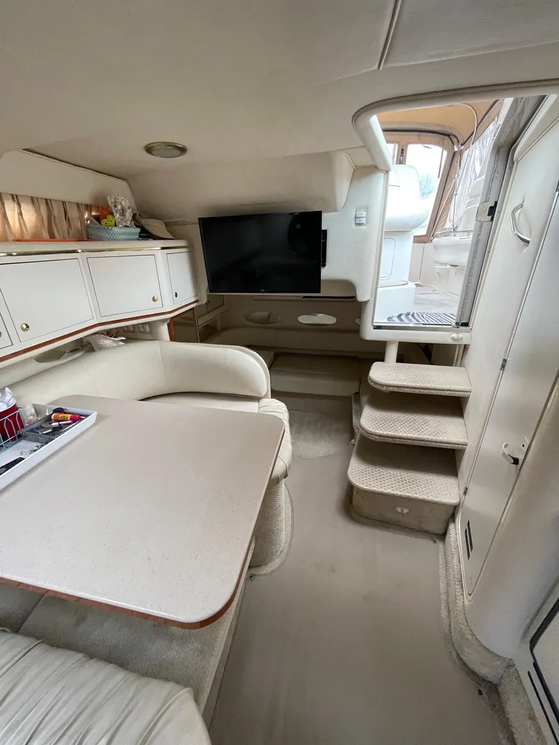 Slide: The Image of Interior of 2001 Sea Ray 310 Sundancer yacht with seating and stairs. - 18