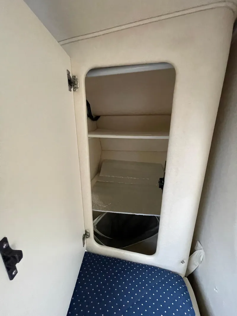 Slide: The Image of Interior storage cabinet on 2001 Sea Ray 310 Sundancer boat. - 19