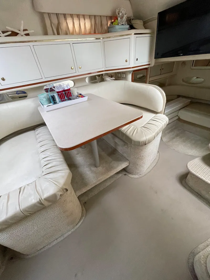 Slide: The Image of Interior of 2001 Sea Ray 310 Sundancer with cozy seating and dining area. - 28
