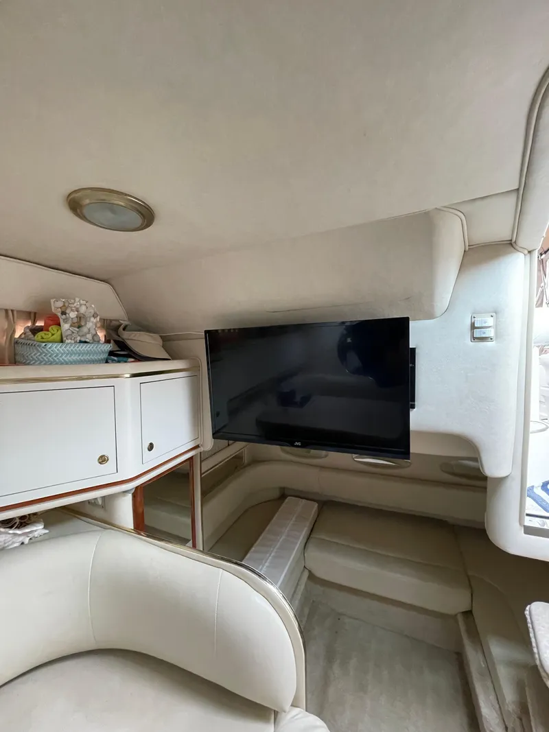 Slide: The Image of Interior of 2001 Sea Ray 310 Sundancer with TV and seating area. - 29