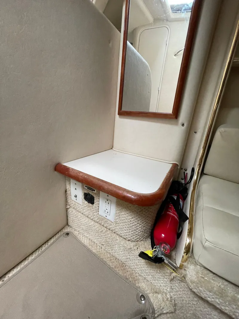 Slide: The Image of 2001 Sea Ray 310 Sundancer cabin interior with mirror, shelf, and fire extinguisher. - 31
