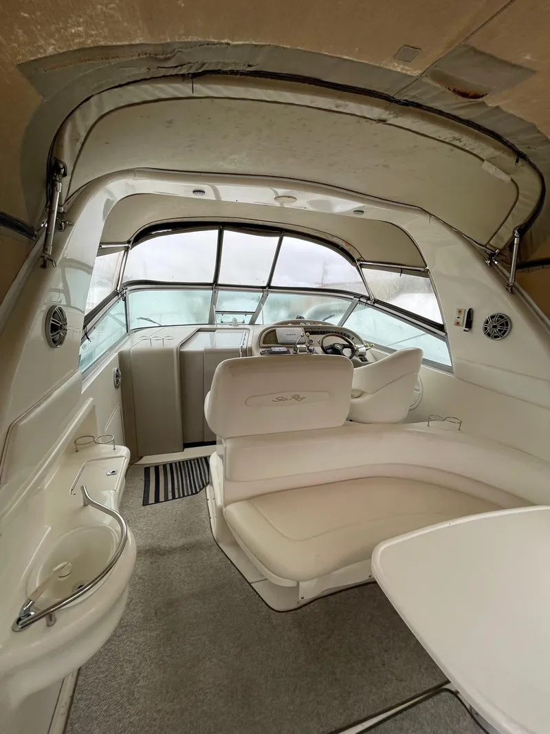 Slide: The Image of Interior of 2001 Sea Ray 310 Sundancer boat with helm and seating area. - 36