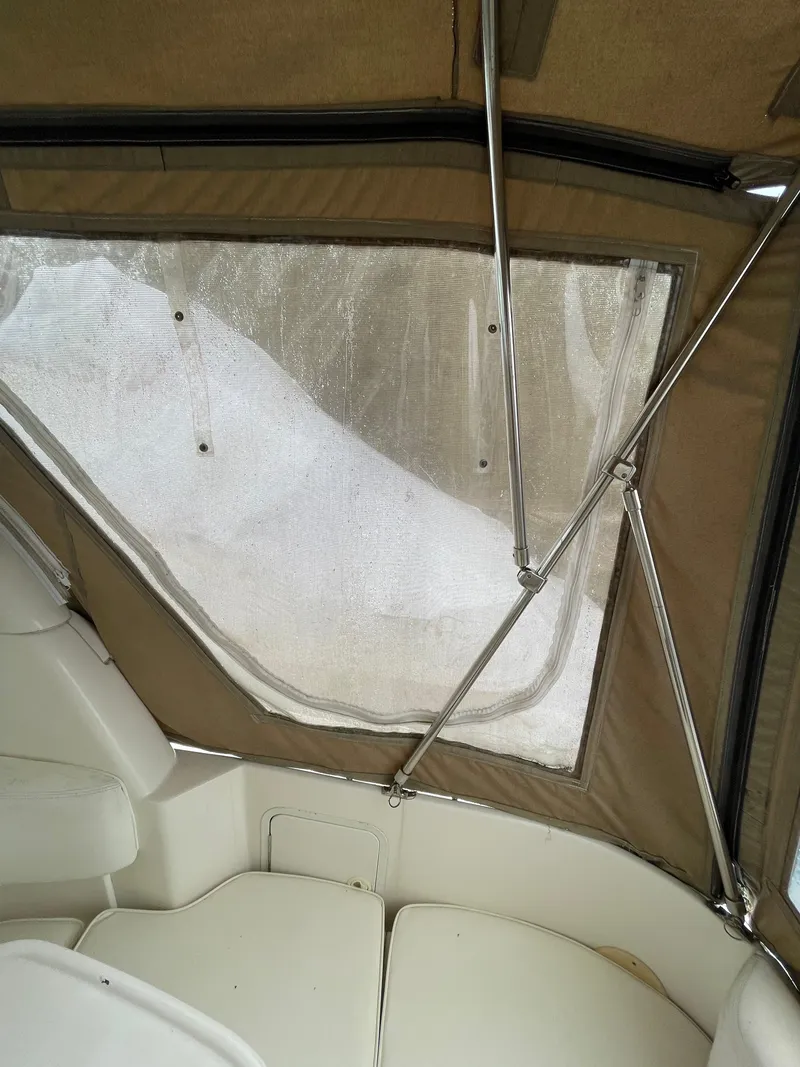 Slide: The Image of 2001 Sea Ray 310 Sundancer interior with beige canopy and seating. - 37