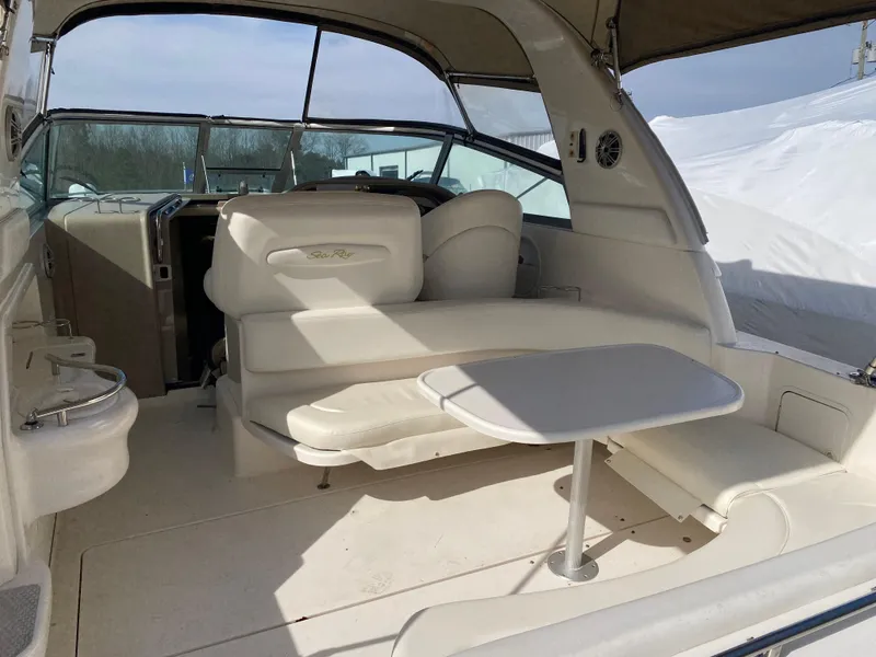 Slide: The Image of 2001 Sea Ray 310 Sundancer interior with seating and table, showcasing spacious design. - 40
