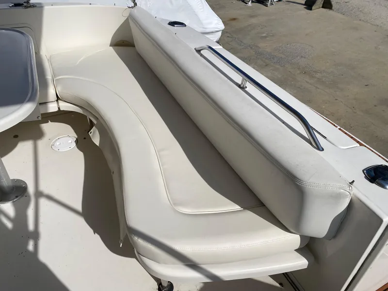 Slide: The Image of 2001 Sea Ray 310 Sundancer boat seating area with white upholstery and stainless steel rail. - 41