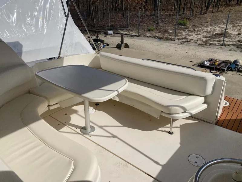 Slide: The Image of 2001 Sea Ray 310 Sundancer boat interior with white seating and table. - 42