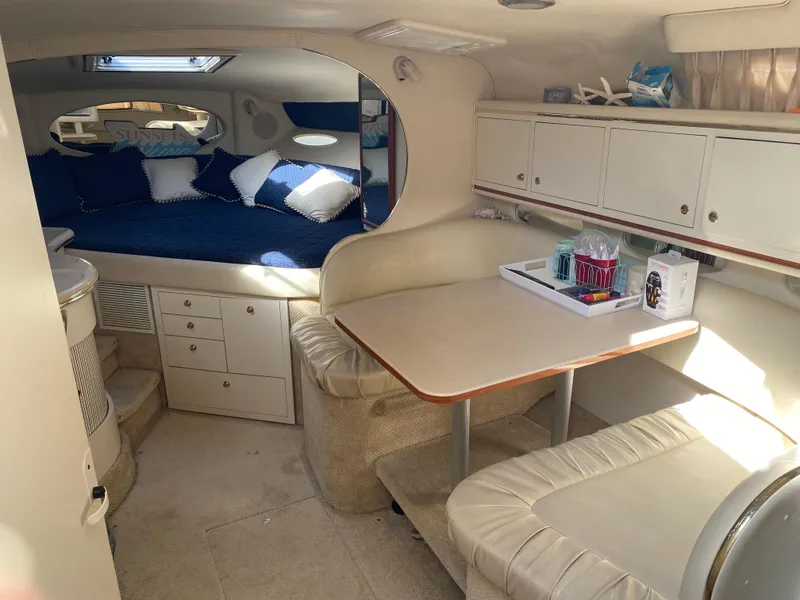 Slide: The Image of Interior of 2001 Sea Ray 310 Sundancer with cozy seating and sleeping area. - 43