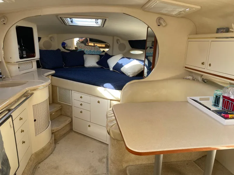 Slide: The Image of Interior of 2001 Sea Ray 310 Sundancer with cozy seating and kitchenette. - 44