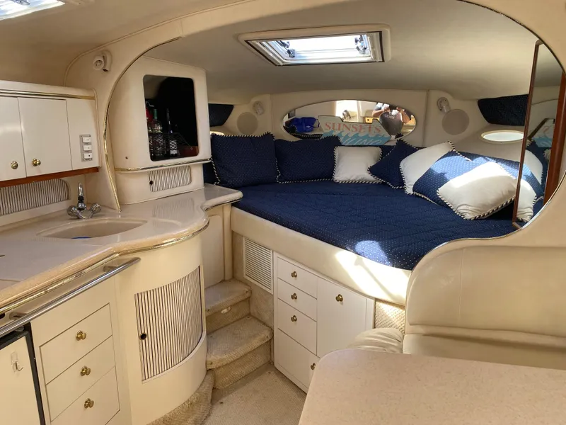 Slide: The Image of Interior of 2001 Sea Ray 310 Sundancer with cozy bed and kitchenette. - 45