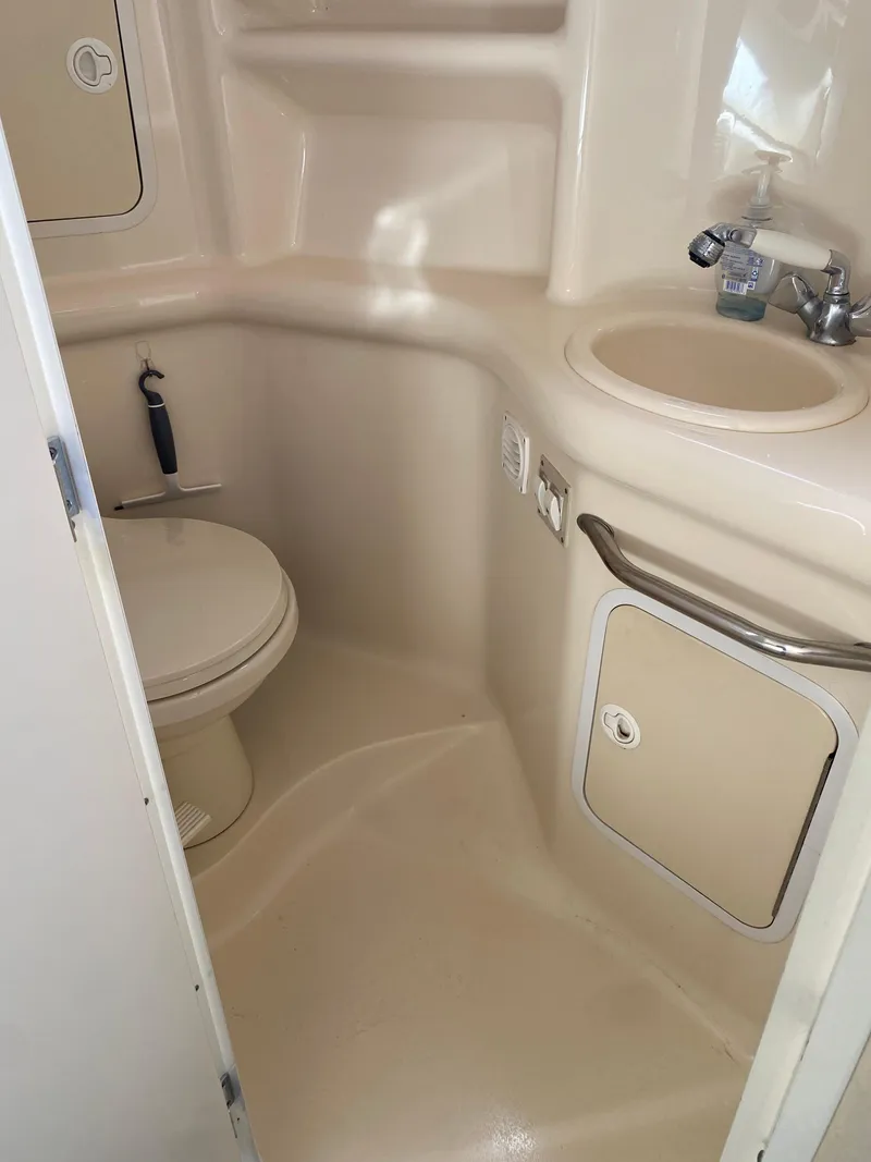 Slide: The Image of 2001 Sea Ray 310 Sundancer bathroom with sink and toilet. - 49
