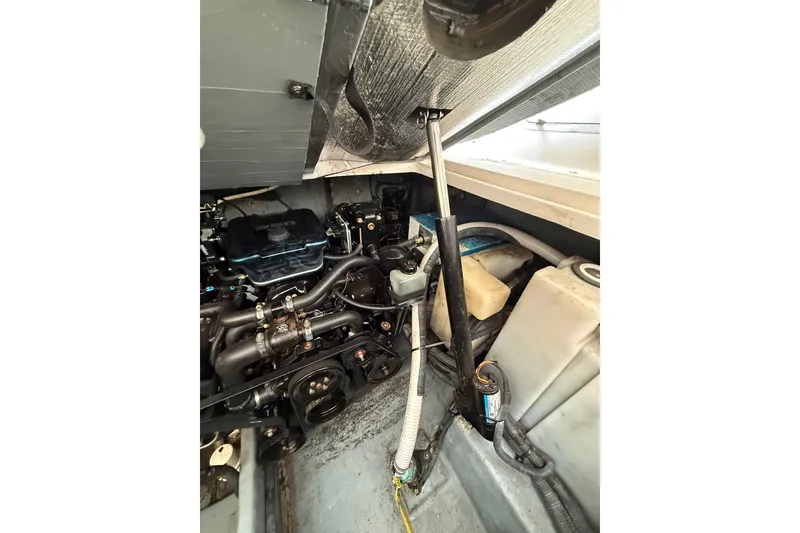 Slide: The Image of Engine compartment of a 2001 Sea Ray Sundancer 310 boat, showcasing mechanical components. - 59