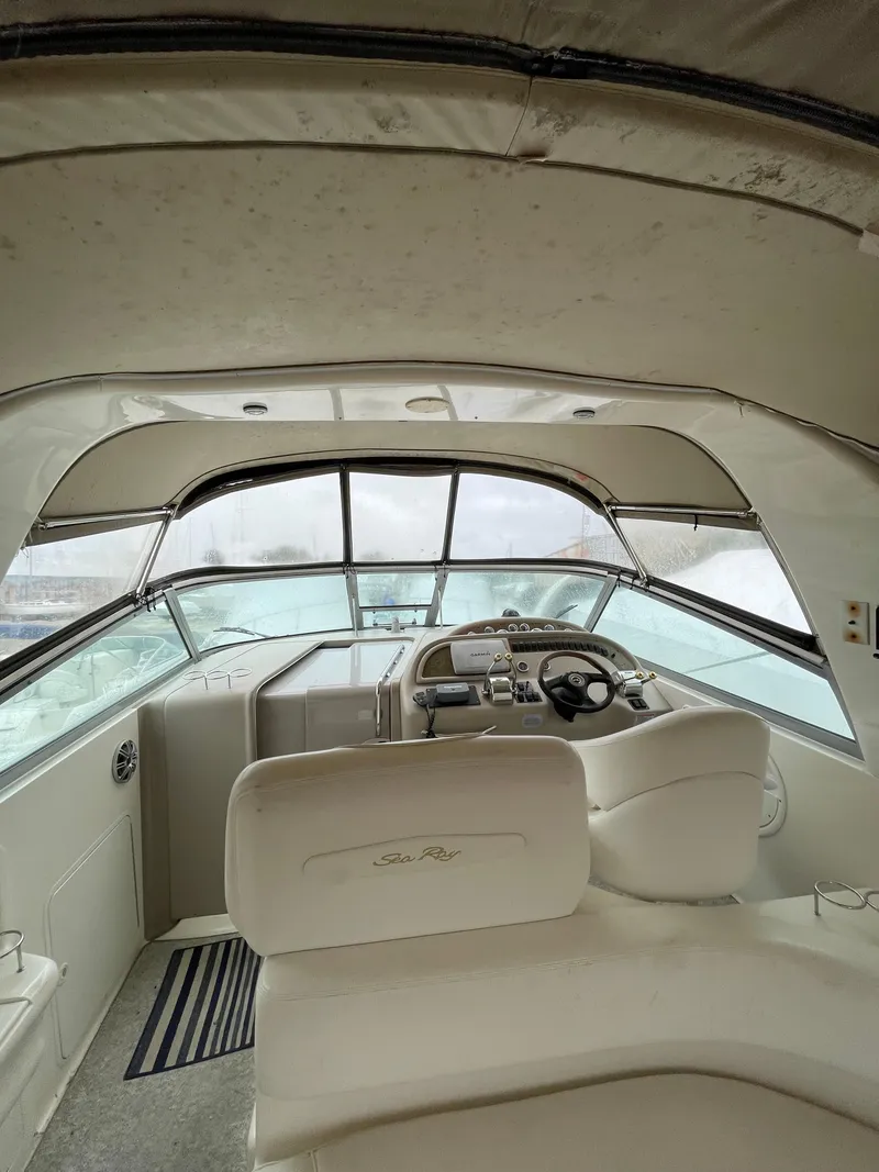 Slide: The Image of Interior view of 2001 Sea Ray 310 Sundancer boat cockpit with steering wheel. - 8