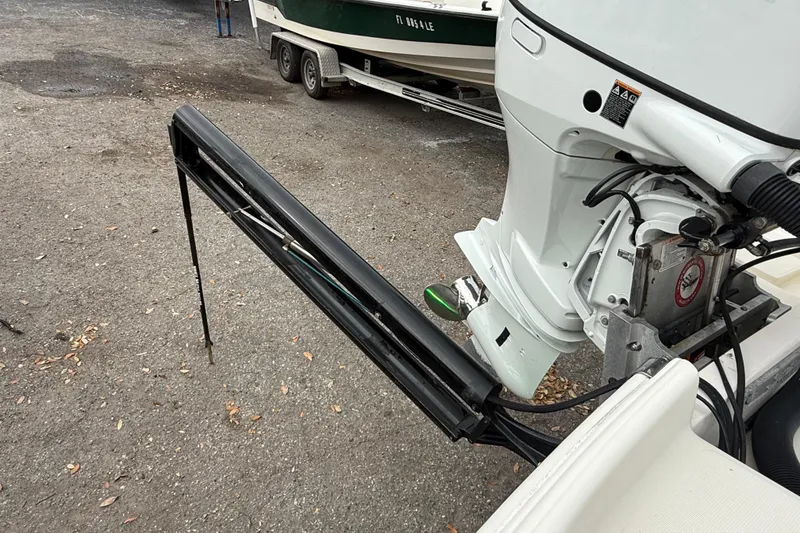 Slide: The Image of 2003 Scout 240 Bay Scout boat motor and power pole on trailer. - 10