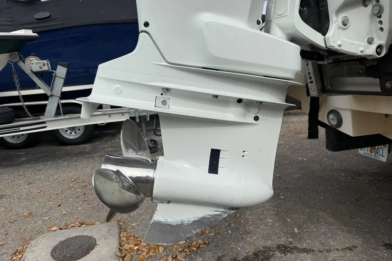 Slide: The Image of Outboard motor of a 2003 Scout 240 Bay Scout boat, showing propeller and lower unit. - 11