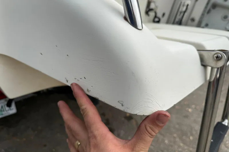 Slide: The Image of Close-up of 2003 Scout 240 Bay Scout boat with visible scratches and wear. - 15