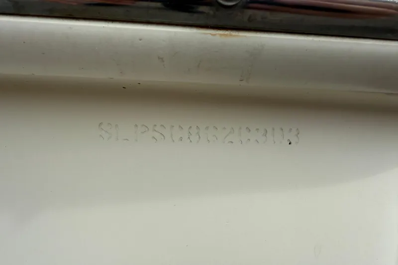 Slide: The Image of 2003 Scout 240 Bay Scout hull identification number on white surface. - 16