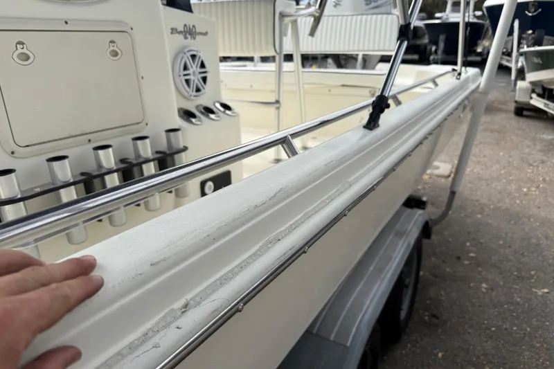 Slide: The Image of 2003 Scout 240 Bay Scout boat interior with rod holders and console details. - 21