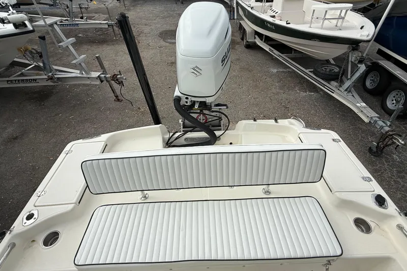 Slide: The Image of 2003 Scout 240 Bay Scout boat with Suzuki outboard motor and white cushioned seating. - 22
