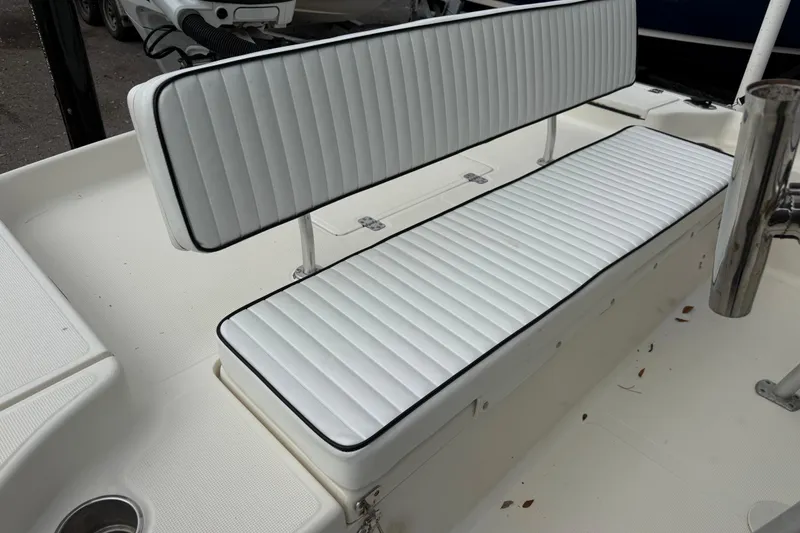 Slide: The Image of 2003 Scout 240 Bay Scout boat with white cushioned seating and stainless steel details. - 23