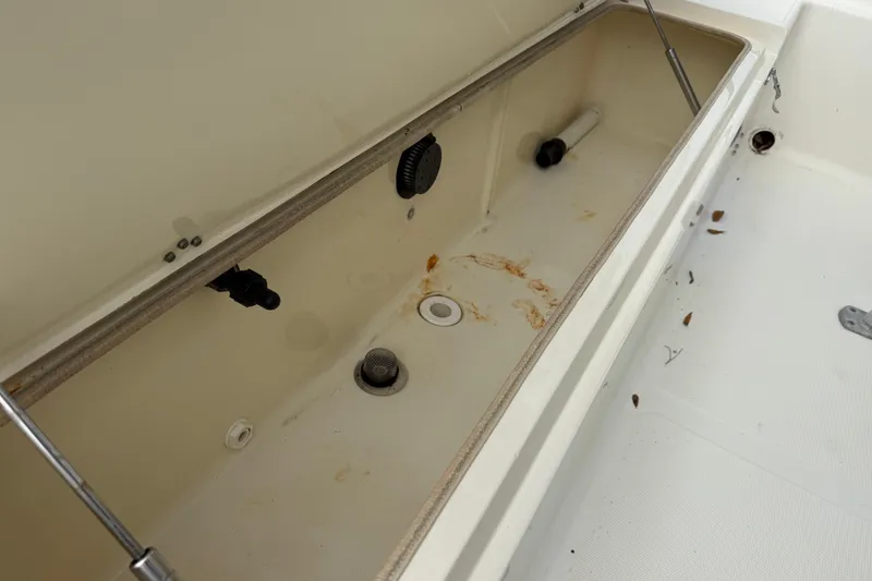Slide: The Image of Open storage compartment in a 2003 Scout 240 Bay Scout boat, showing interior details. - 25
