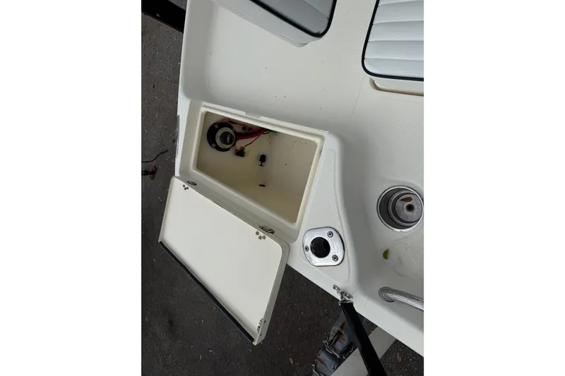 Slide: The Image of Open storage compartment on a 2003 Scout 240 Bay Scout boat deck. - 27