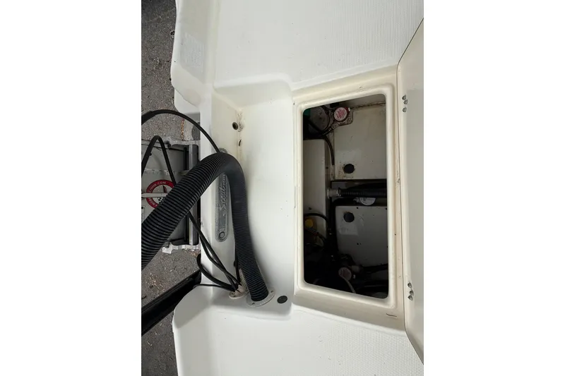 Slide: The Image of 2003 Scout 240 Bay Scout boat compartment with visible wiring and components. - 28
