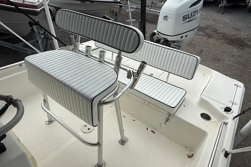 Slide: The Image of 2003 Scout 240 Bay Scout boat interior with seating and Suzuki outboard motor. - 29