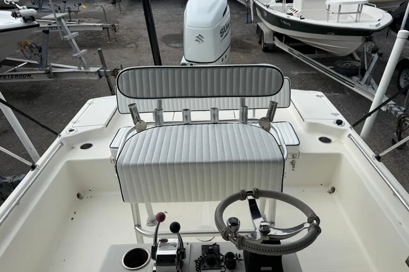 Slide: The Image of 2003 Scout 240 Bay Scout boat interior with steering wheel and seating. - 30