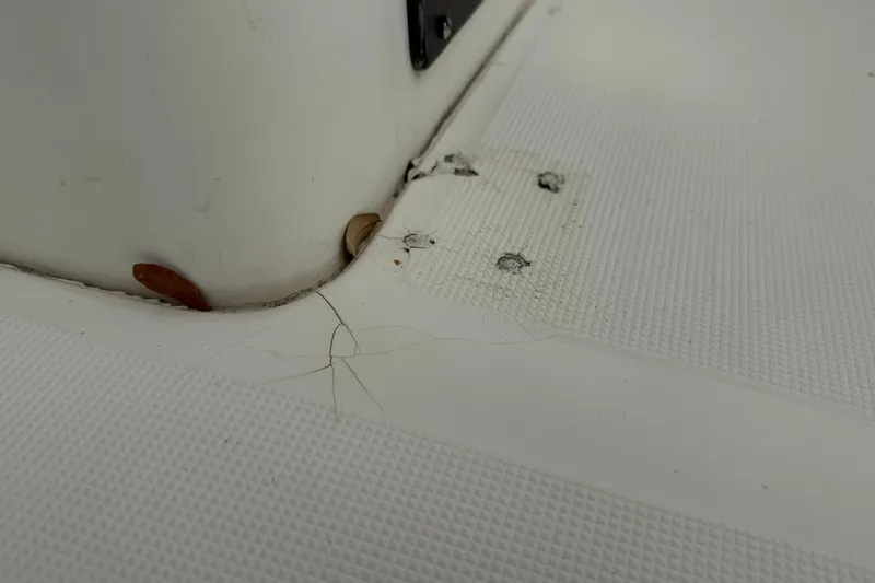 Slide: The Image of Close-up of 2003 Scout 240 Bay Scout boat deck with visible wear and debris. - 35