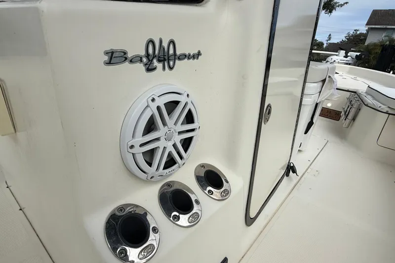 Slide: The Image of 2003 Scout 240 Bay Scout boat interior with speaker and rod holders. - 36