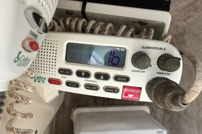 Slide: The Image of Marine radio equipment on a 2003 Scout 240 Bay Scout boat, displaying channel 16. - 38