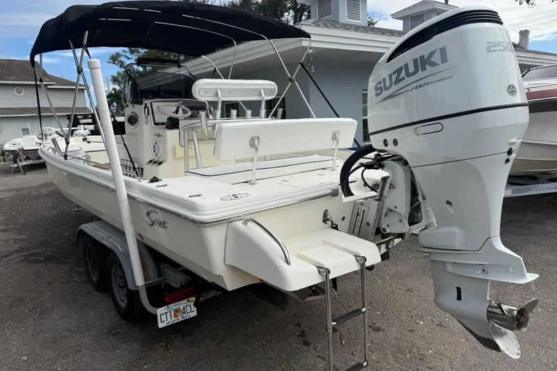 Slide: The Image of 2003 Scout 240 Bay Scout boat with Suzuki 250 outboard motor on trailer. - 4