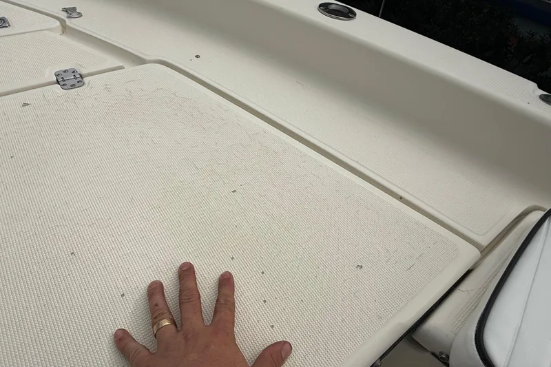 Slide: The Image of Hand on deck of 2003 Scout 240 Bay Scout boat, showcasing textured surface. - 43