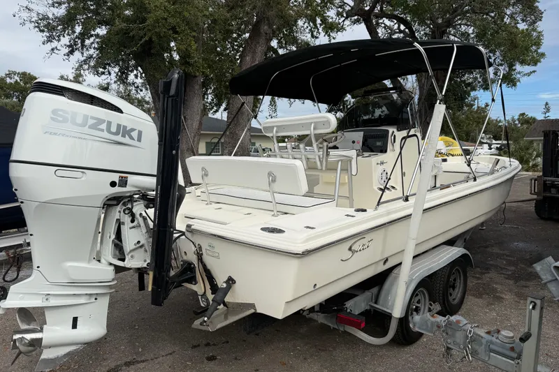 Slide: The Image of 2003 Scout 240 Bay Scout boat with Suzuki outboard motor on trailer. - 6