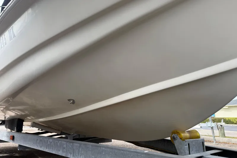 Slide: The Image of 2003 Scout 240 Bay Scout boat on trailer, close-up of hull design. - 7