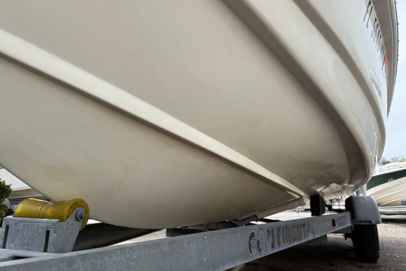 Slide: The Image of 2003 Scout 240 Bay Scout boat on trailer, side view. - 8