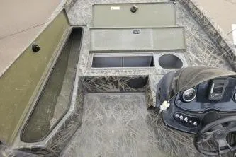 Slide: The Image of 2016 Lowe Stinger 175 boat interior with storage compartments and control panel. - 3