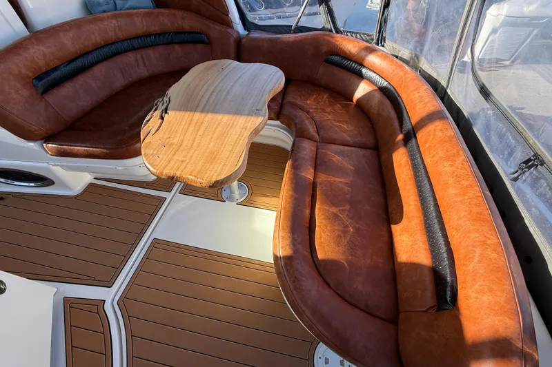 Slide: The Image of Luxurious 2006 Sea Ray 340 Sundancer interior with leather seating and wooden table. - 11