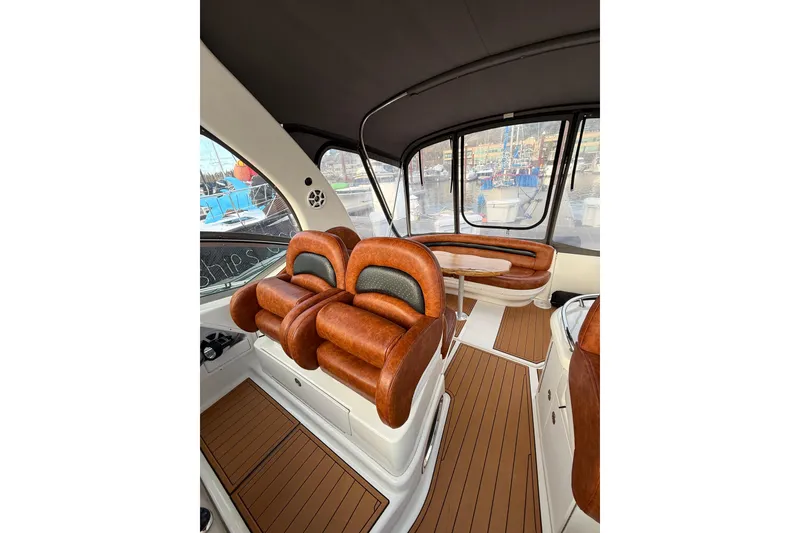 Slide: The Image of 2006 Sea Ray 340 Sundancer interior with leather seating and wood flooring. - 12