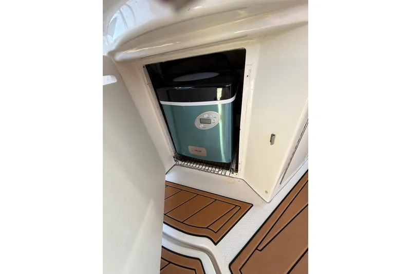 Slide: The Image of 2006 Sea Ray 340 Sundancer interior with built-in appliance and teak flooring. - 14