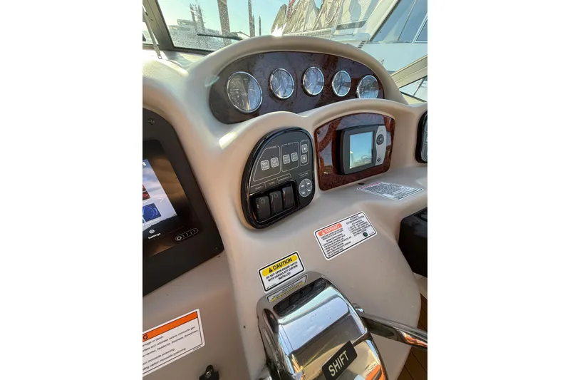 Slide: The Image of 2006 Sea Ray 340 Sundancer dashboard with gauges and controls. - 16
