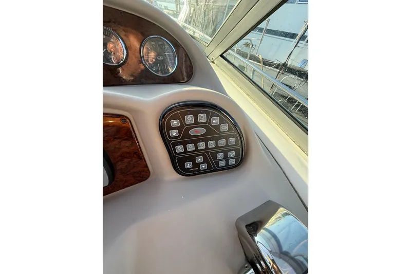Slide: The Image of Control panel of a 2006 Sea Ray 340 Sundancer boat, featuring various switches and gauges. - 17