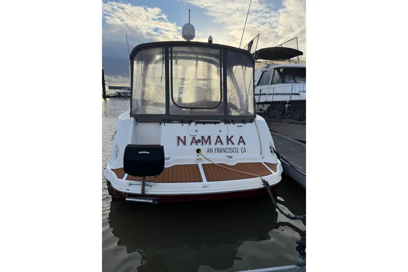 Slide: The Image of 2006 Sea Ray 340 Sundancer boat docked, rear view with "NAMAKA" and San Francisco, CA text. - 3
