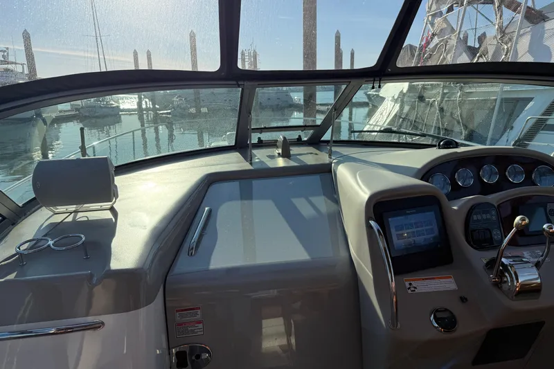 Slide: The Image of 2006 Sea Ray 340 Sundancer helm with modern controls and marina view. - 30