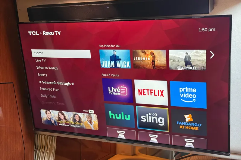 Slide: The Image of TCL Roku TV displaying streaming apps on a Sea Ray 340 Sundancer, 2006 model. - 34